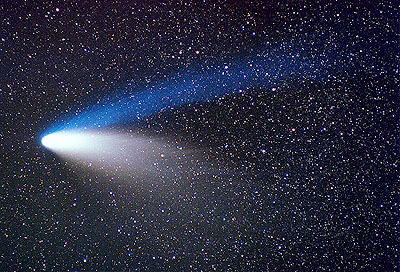 Picture of comet Hale-Bopp showing the white/yellow dust tail, the clearblue ion tail and countless background stars